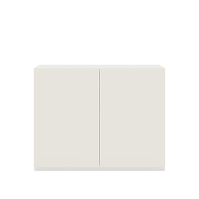 Vor weißem Hintergrund sieht man ein cremeweißes Sideboard mit zwei Drehtüren. Die Türen sind grifflos.