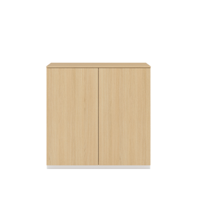Vor weißem Hintergrund sieht man ein Sideboard aus Eichenholz mit zwei Drehtüren. Auf dem Schrank ist eine Abdeckplatte aus Eichenholz angebracht.